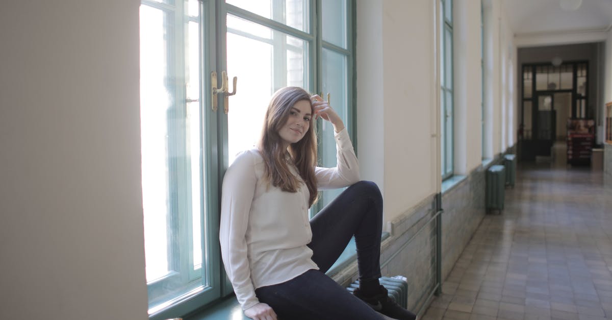 Luggage on changed booking - Young female student relaxing during break in university corridor