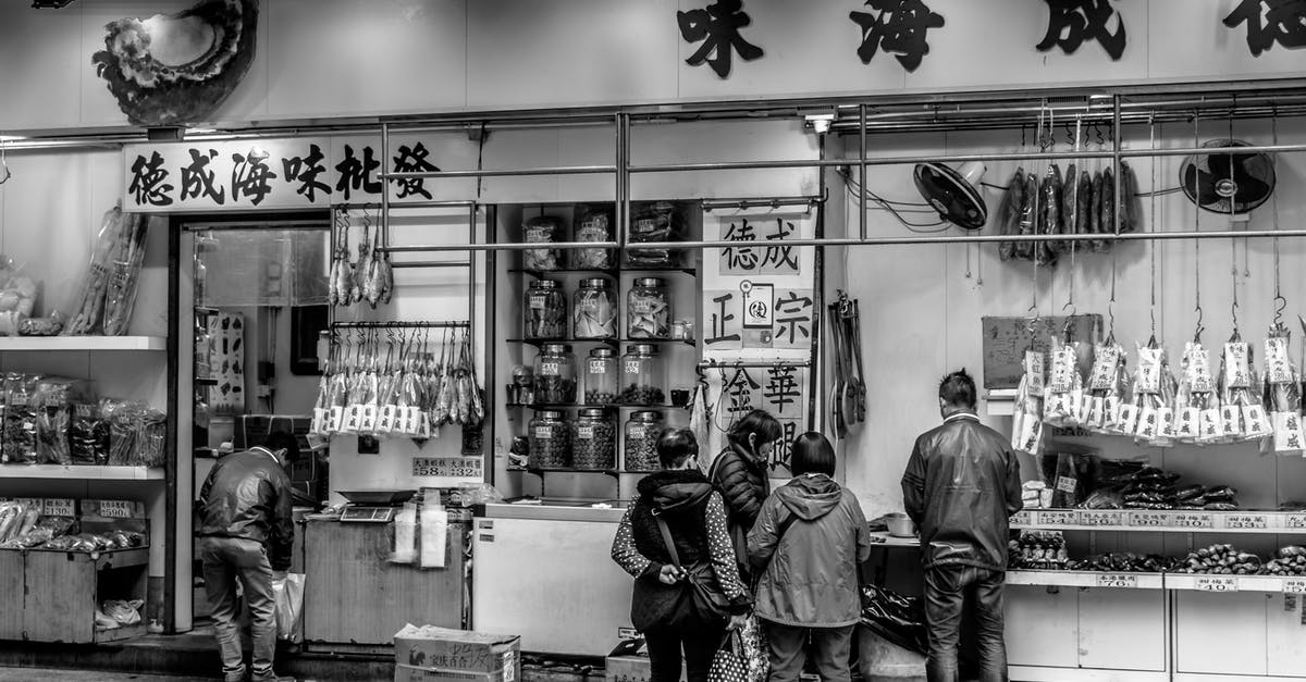 Macau/Hong Kong: Visa for going back and forth - Grayscale Photography of People Standing in Front of Store