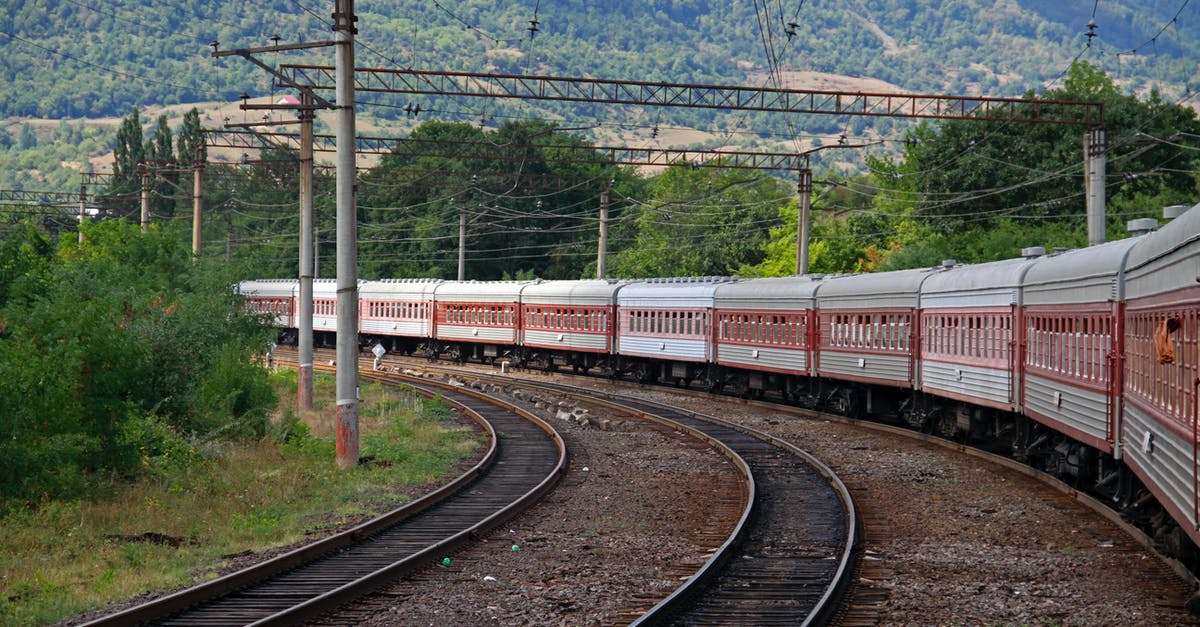 Maeklong Railway Timetable - Red and White Train on Rail Tracks