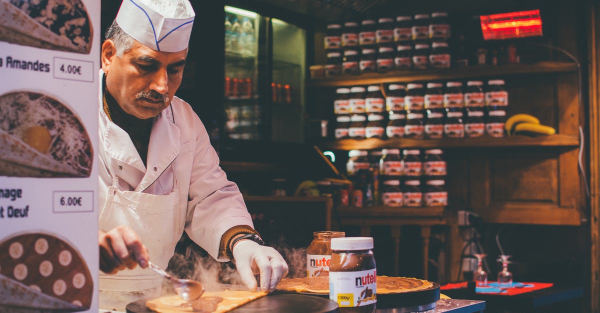 Making Restaurant Reservations in Paris from America - Person Cooking Inside Kitchen