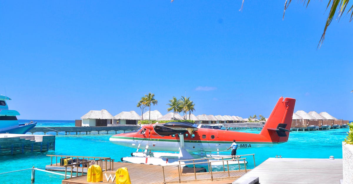 Maldives: Water villas tours - White and Red Seaplane on Body of Water