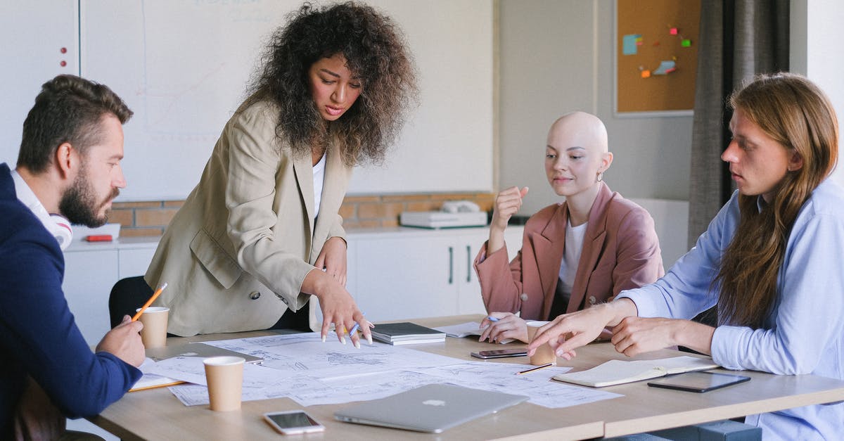 Marketing Leg and Code Share Flight - Concentrated coworkers having meeting at table