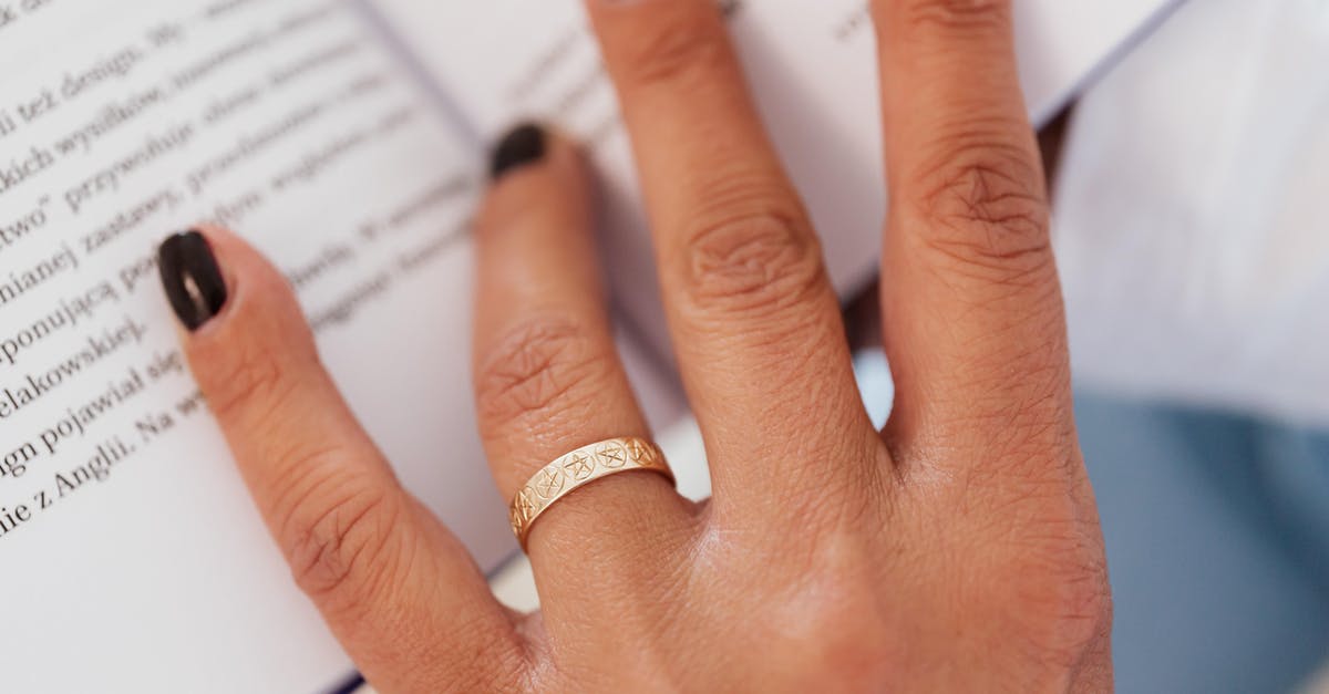 Married name on easyjet booking - Closeup hand of faceless woman with ring on nameless finger paging book while resting at home