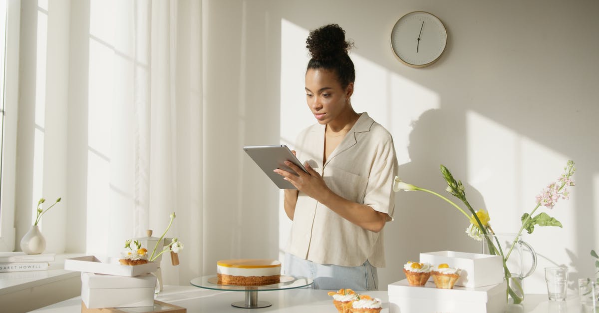 May I take a parcel as my "personal item"? - Man in White Shirt Using Silver Ipad