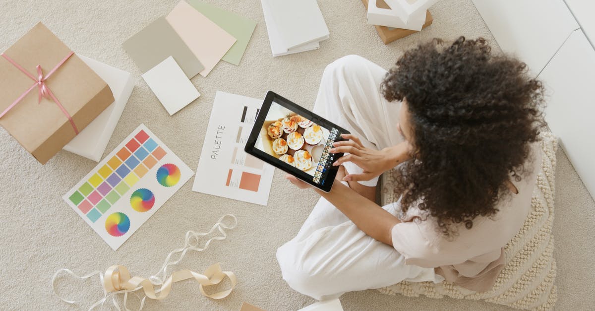 May I take a parcel as my "personal item"? - Woman in White Shirt Holding Black Tablet Computer