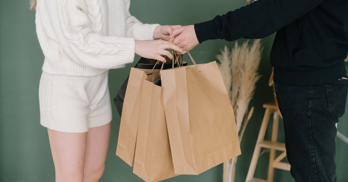 May I take a parcel as my "personal item"? - Two People Holding Shopping Bags