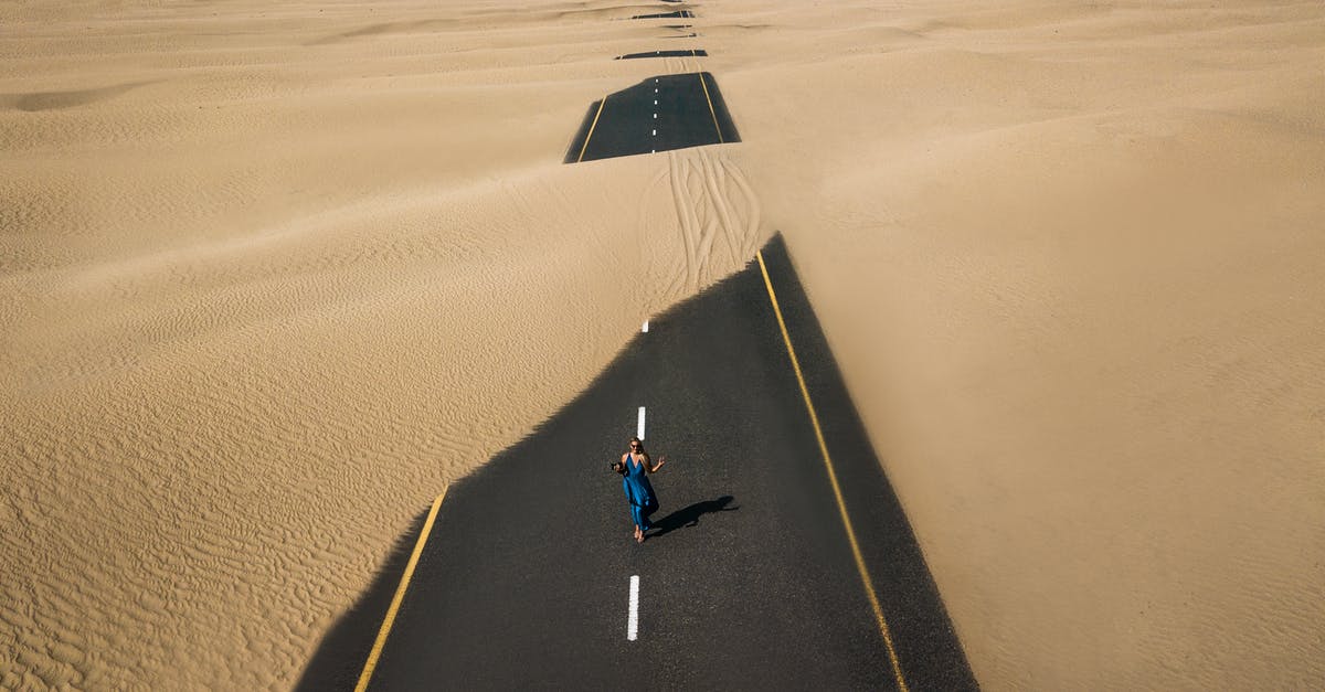 May I travel with my father's ashes into Israel? - Bird's Eye View Photography of Road in the Middle of Desert