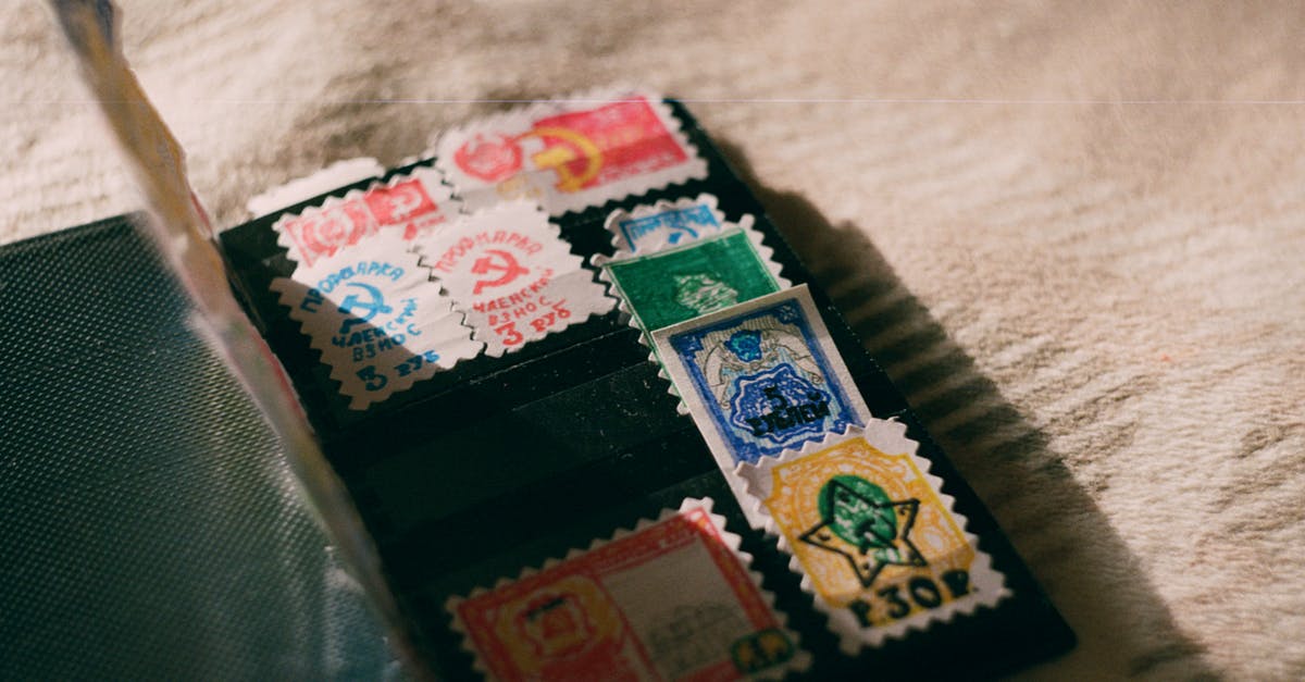 Meaning of various fields on a Schengen visa stamp - Collection of old stamps on blanket at home