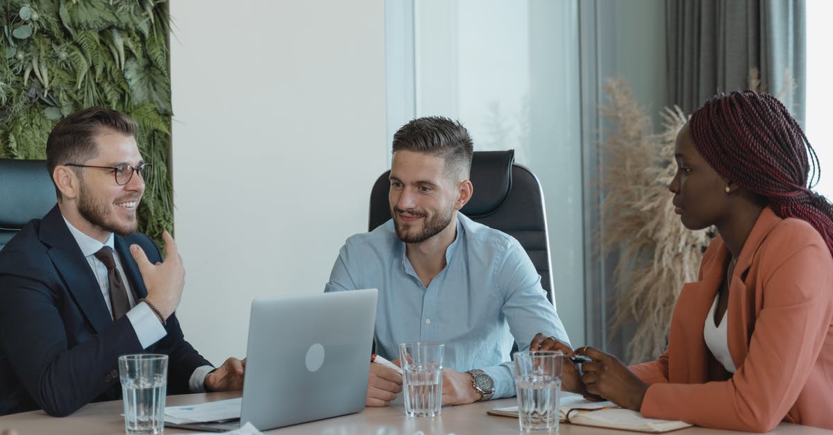 Meeting place in CDG - Coworkers in a Conference Room having a Meeting