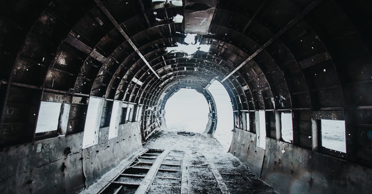 Messy airplane booking - what are my options? - Interior of desolated old empty destructed airplane with dirty floor covered with snow and holes on walls and ceiling