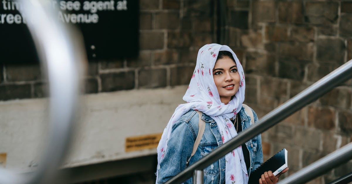 Metro areas with the biggest daytime bulge in population? [closed] - Happy Muslim lady wearing white hijab and denim coat walking upstairs from subway in megapolis in daylight in New York USA