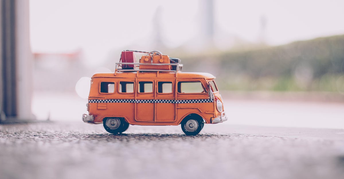 Mexico to Tierra de Fuego, bus or own car? - Orange Van Die-cast Model on Pavement