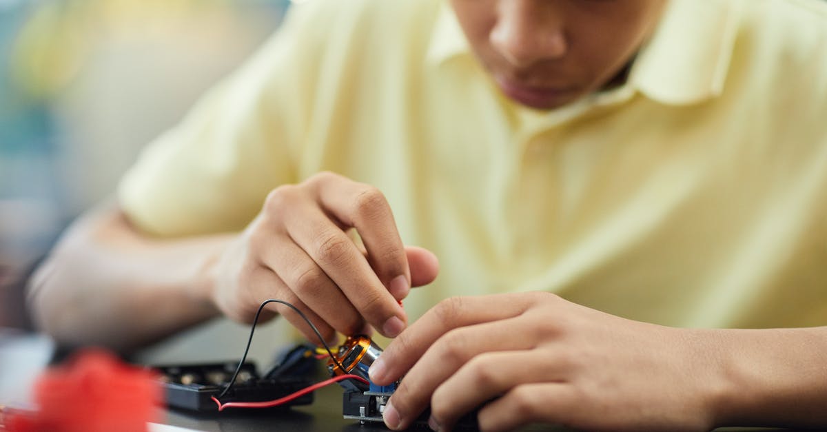 Mispar Zehut - Student VISA A/2 [closed] - Boy Fixing an Electronic Device