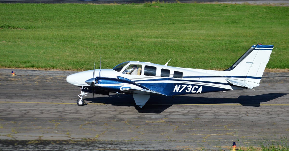 Missed flight USA airport tax refund? - White and Blue Airplane on Brown Field