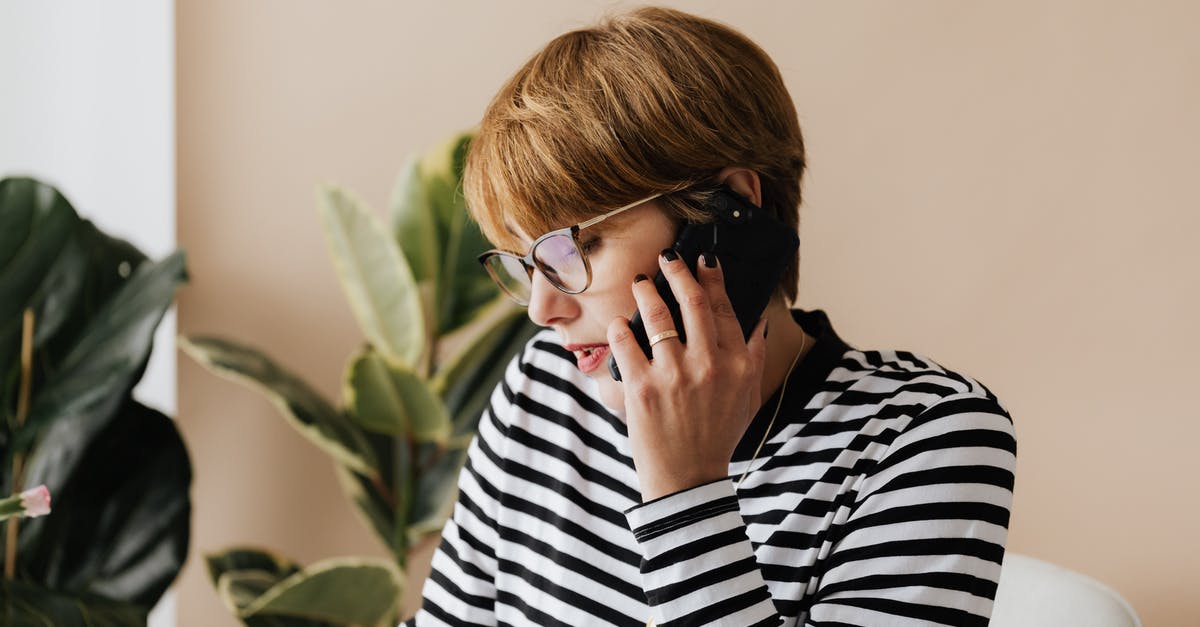 Mobile phone connection in Macedonia for short visit - Serious businesswoman having phone conversation in light workplace