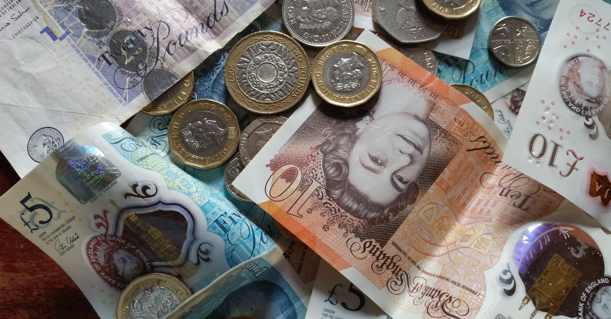 Money at UK border control - Silver and Gold Coins on White Printer Paper