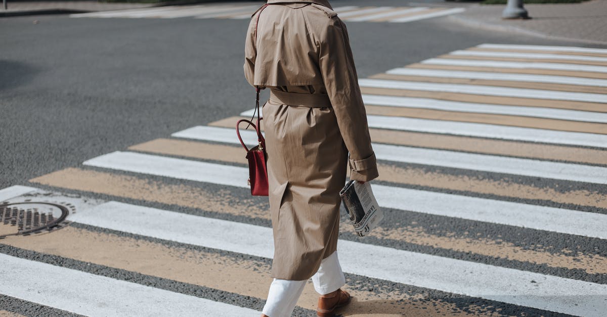 Mongolia-Russia crossing at Naushki [duplicate] - Woman in Brown Coat and White Pants Walking on Pedestrian Lane