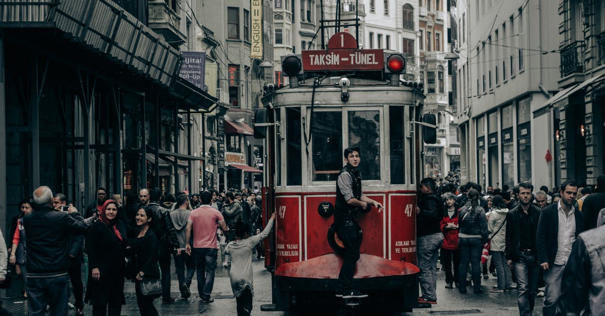 Moscow to Istanbul by train [closed] - People Walking on Street Near Red Tram