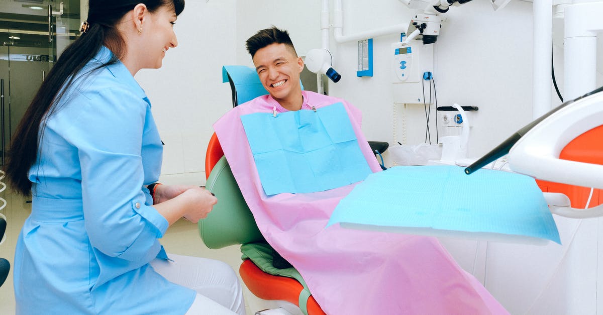 Mother's Visit Visa Refused, 'visit her some other country' [closed] - Cheerful ethnic male patient sitting in dental chair in clinic