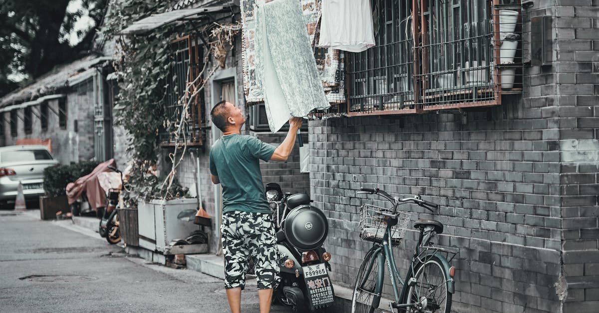 Motorbike rental in Japan - Man Getting the Towel In Front of a House
