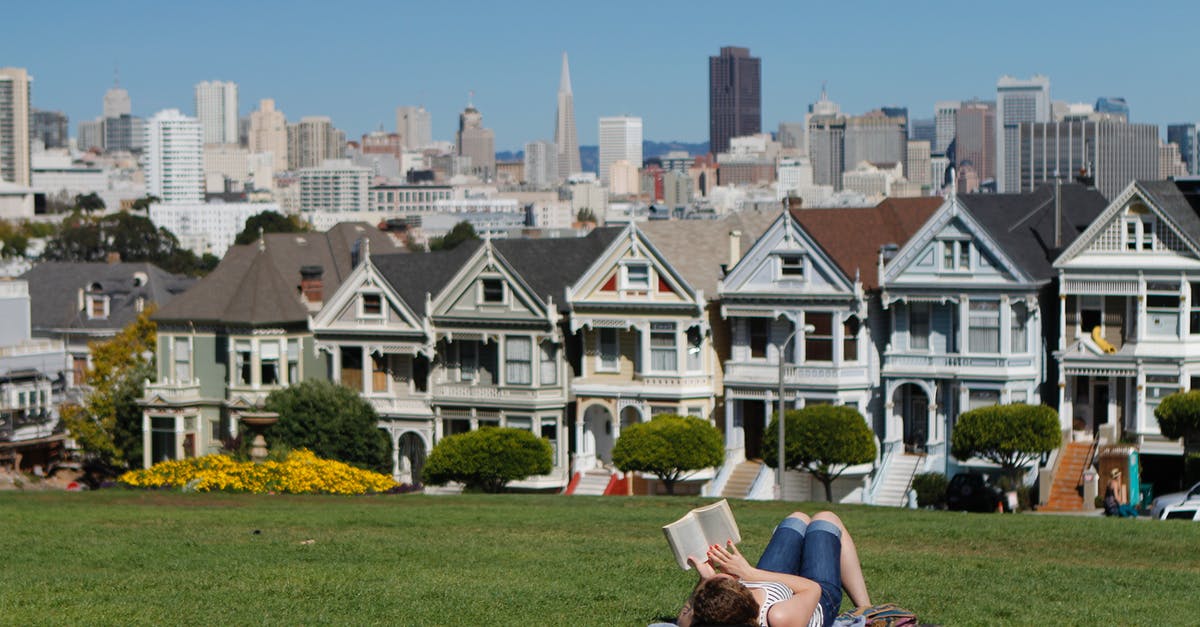 Multiday parking in San Francisco - Woman Lying on White Textile in Grass Field during Daytime