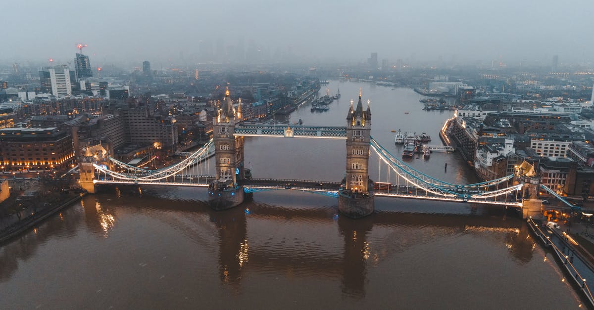 Multimodal routing in the UK - what sites/tools? - Aerial view of London city located in England with illuminated Tower Bridge on River Thames near modern buildings under gray cloudy sky in foggy day