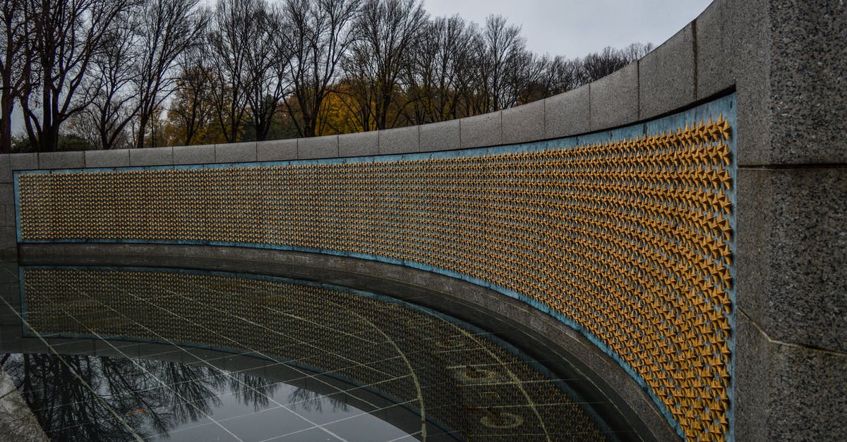 Museums about Japan's World War II history - Golden stars on Freedom Wall at World War II Memorial located in in National Mall in Washington DC against gloomy sky