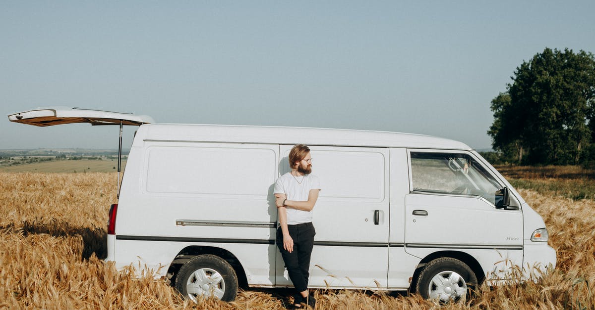 Must US-issued enhanced driver licenses have a full middle name? - Photo of a Man Leaning on White Van