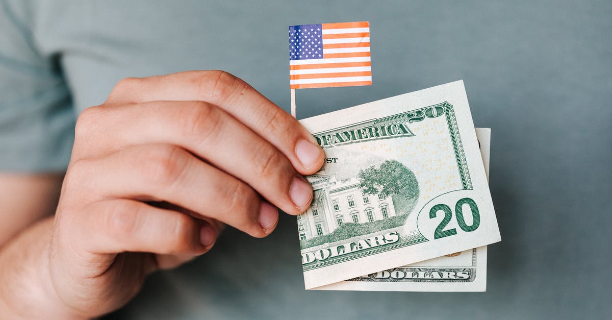 My aunt is paying for my trip to the US. How can I demonstrate that when applying for a B1/B2 visa? [closed] - Crop person showing twenty dollar bill and miniature USA flag