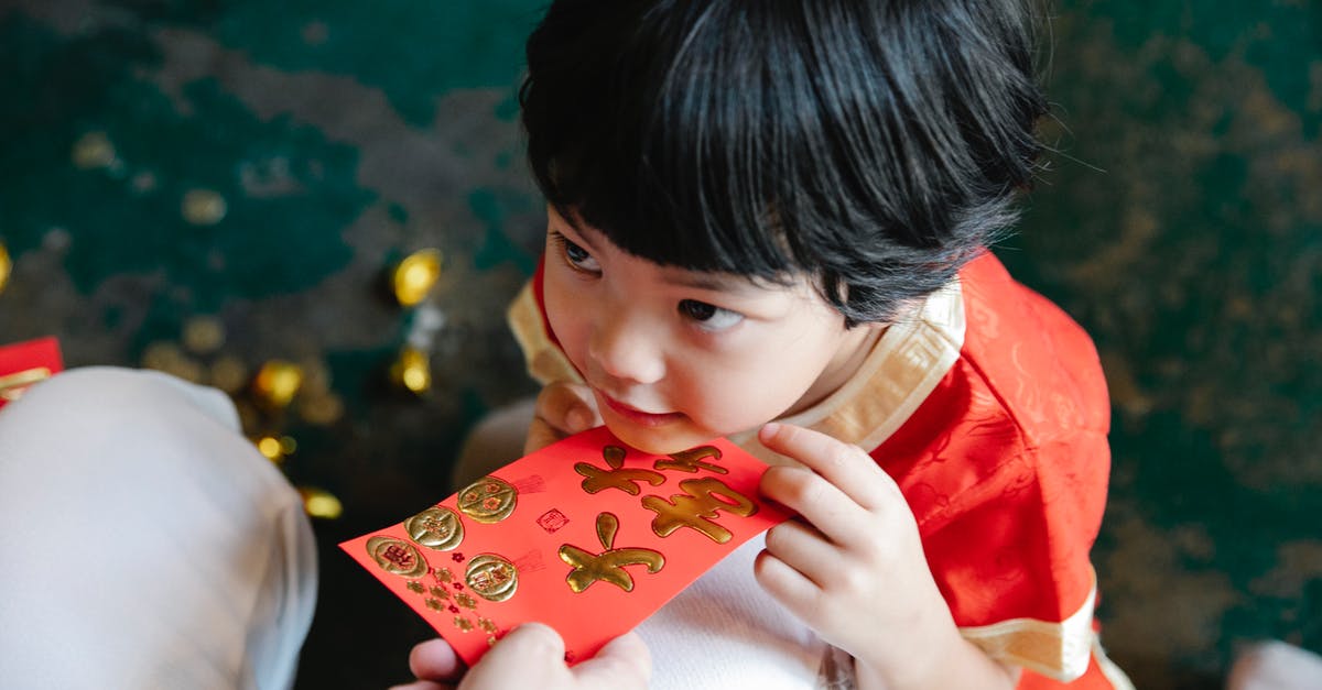 My son has overstayed his visa in Cambodia. He has no money. What can I do? - Crop mother giving hongbao red packet to son during New Year party