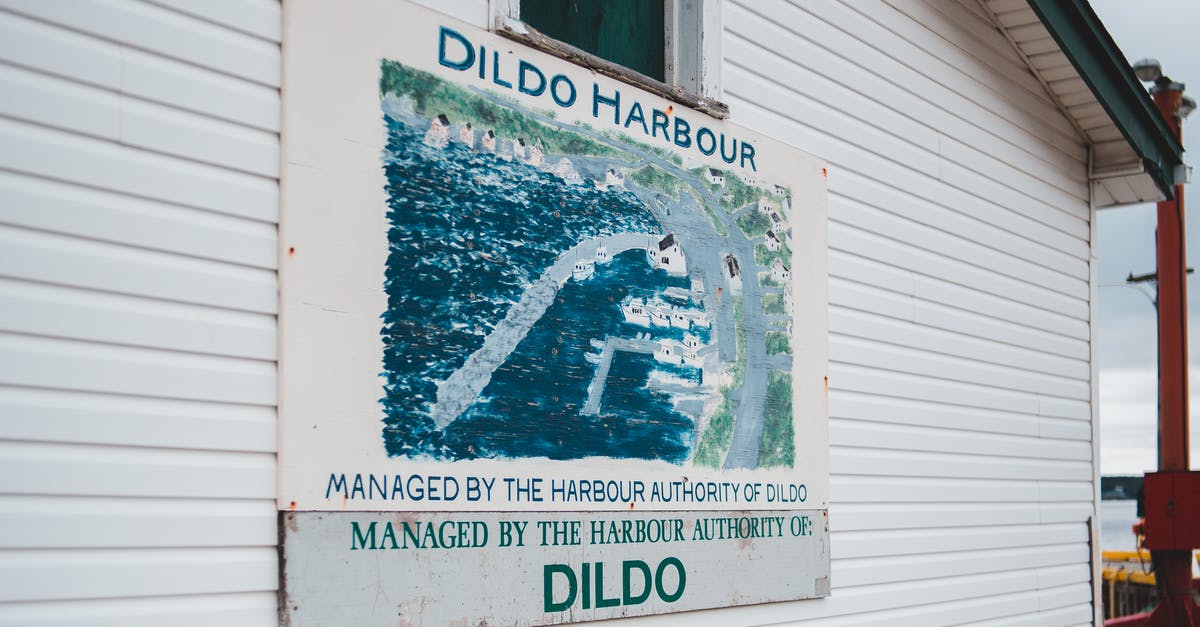 Name misspelled in visa status update notice - Signboard on cottage with location name Dildo Harbour