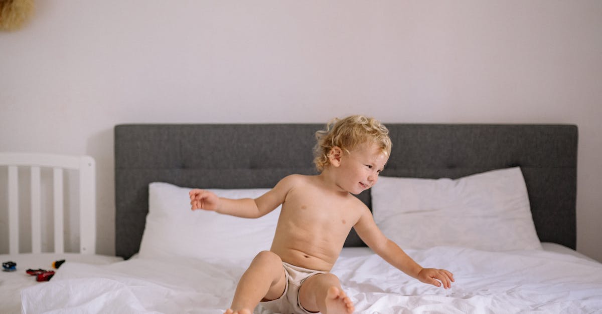 Nappies (diapers) and baby wipes in Panama and Costa Rica - Little Boy Sitting on a Bed in a Diaper and Smiling 