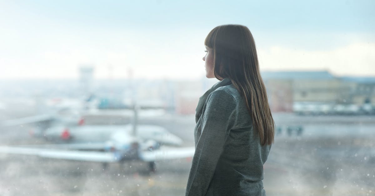 National flight with expired tourist visa - Woman Looking Through the Glass Wall