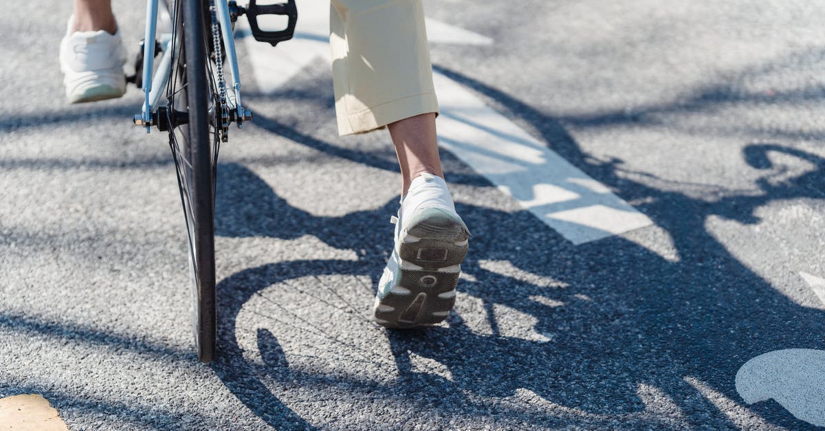 Need cycling route options from Bangkok to Siem Reap (via Poi Pet) [closed] - Crop person riding bicycle on street