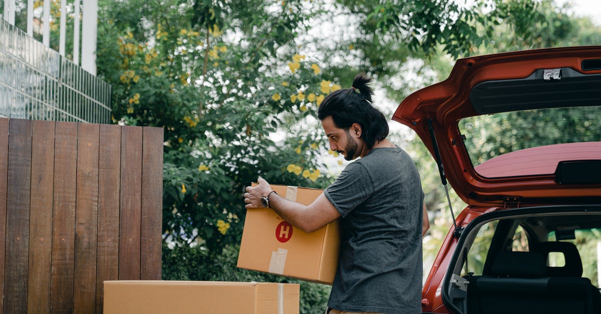 Need to carry heavy load to Goa on charity mission - Young male taking boxes out of luggage boot of car