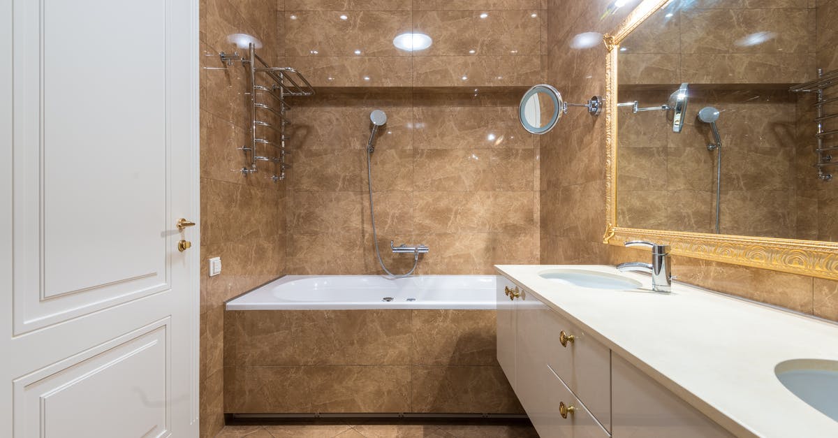 Need to leave for double entry china visa? - Bathroom interior with bathtub and sinks under mirror