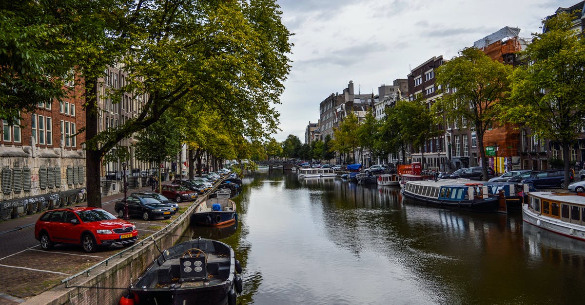 Netherlands Working Holiday Scheme for Aussies - City historical district with moored boats on canal