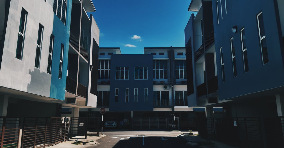 New Jersey area Christmas Town [closed] - From below complex of simple modern geometric buildings with blue facade and balconies located on empty street of city district