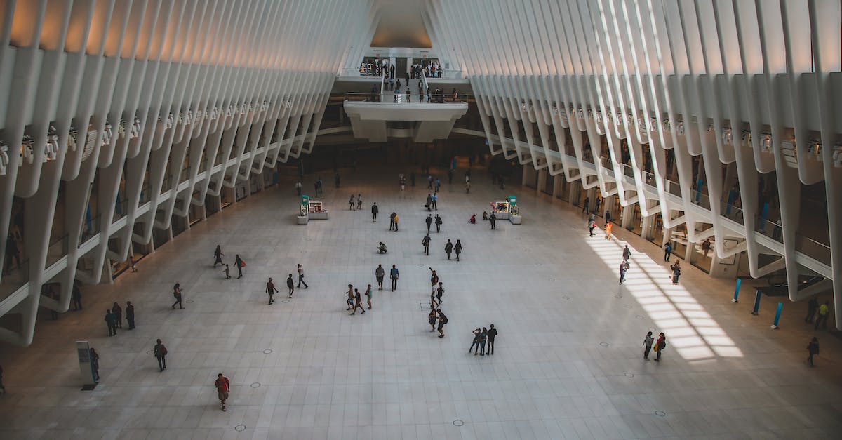 New York airports: JFK vs. EWR/Newark? - People Walking on White Hallway