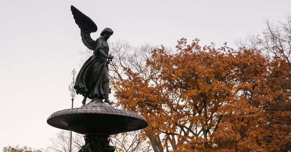 New York park along an old elevated railway? - From below of famous Angel of the Waters statue of Bethesda Fountain placed in Central Park in New York City in autumn time