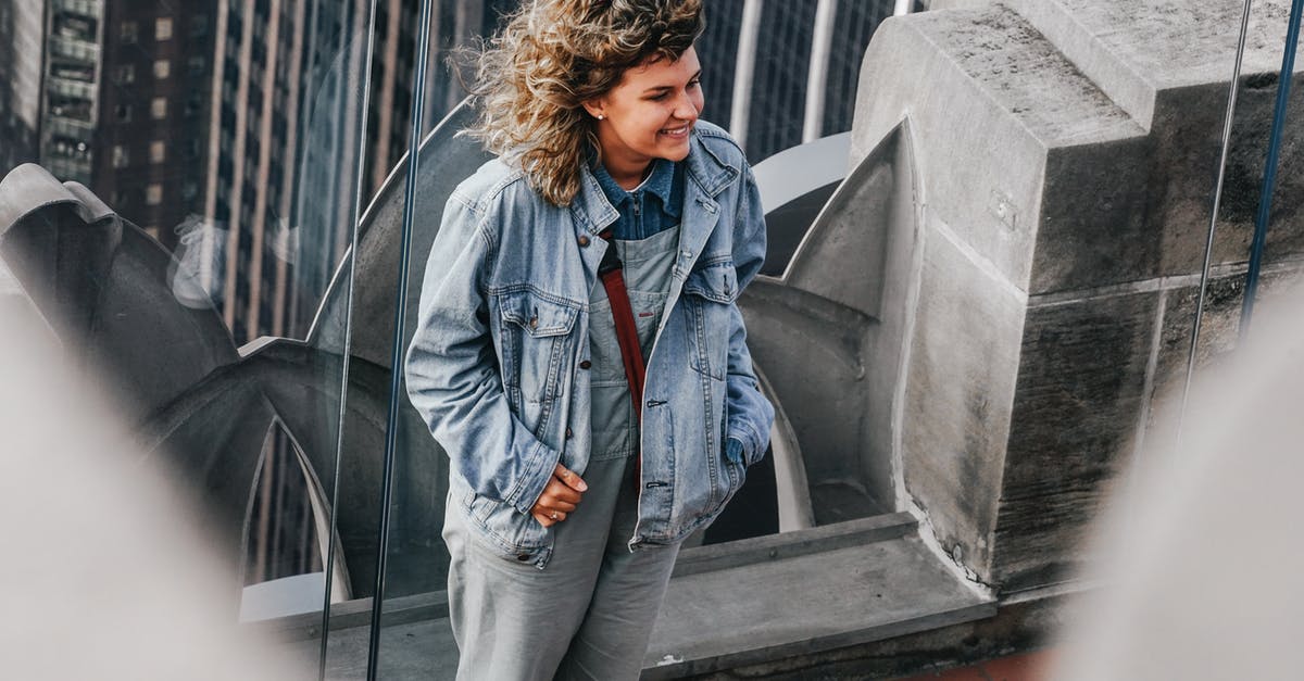 New York subway Q train - view of Brooklyn Bridge - Woman in Blue Denim Jacket Standing Near Gray Concrete Wall