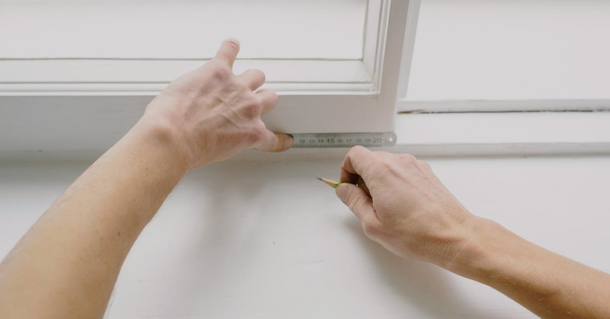 New Zealand precise duration of the "visa waiver visitor visa" - From above of crop unrecognizable male worker measuring window frame with metal ruler and pencil in house