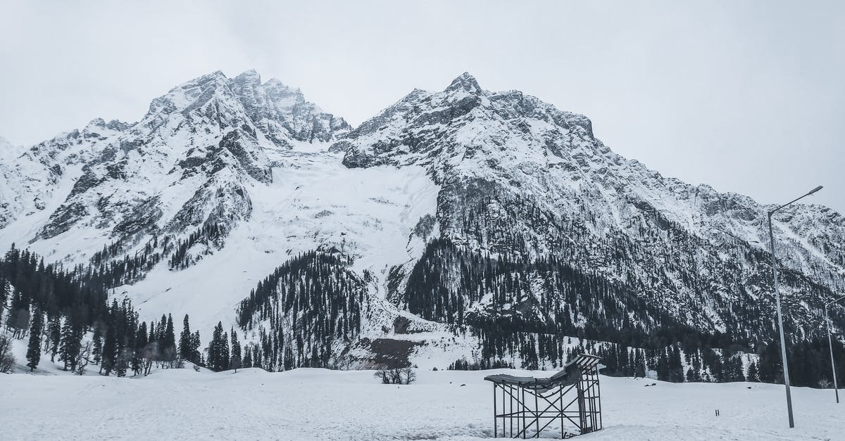 Nigeria to India via Istanbul - Brown Wooden Bench on Snow Covered Ground Near Snow Covered Mountain