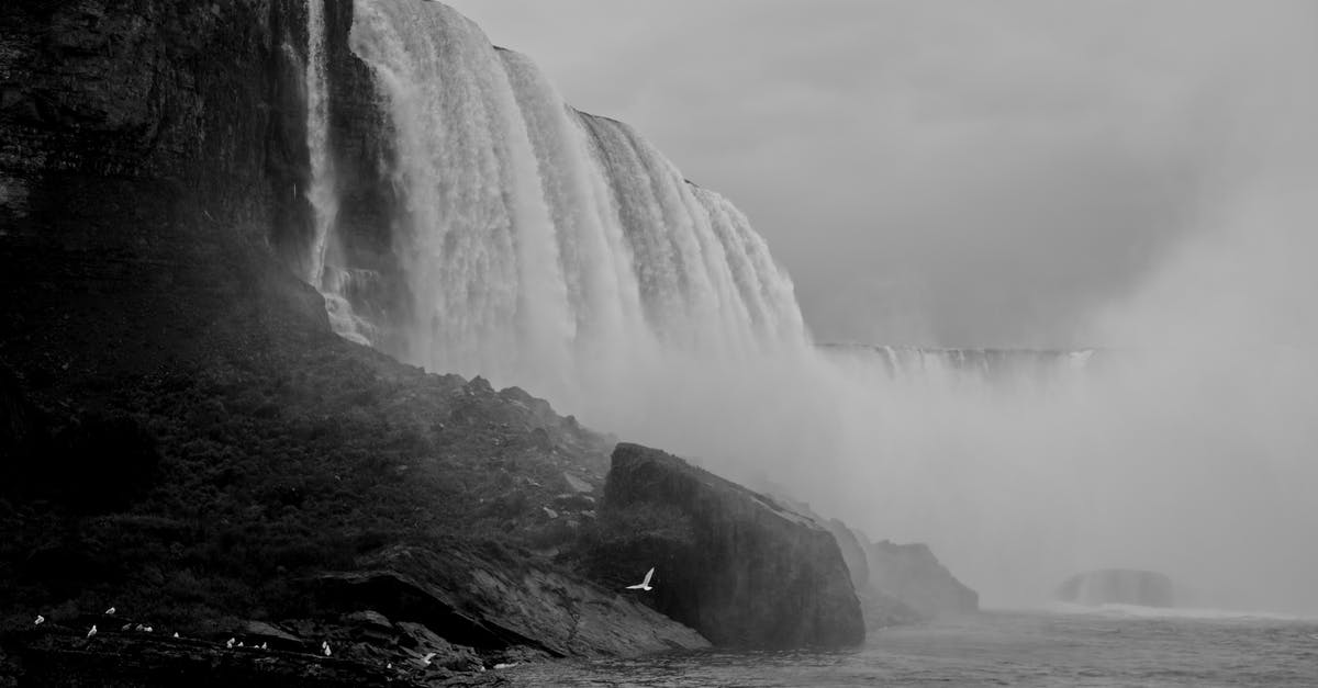 Night travel Niagara Falls to NYC - Grayscale Photo of Waterfalls on Rocky Mountain