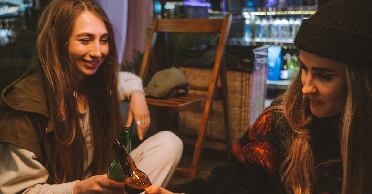 Nightlife in Russia - Woman in Black Long Sleeve Shirt Holding Bottle