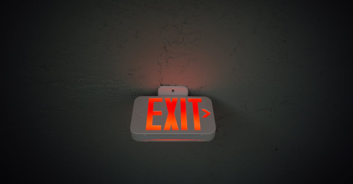 No exit stamp after leaving the Schengen area? - From below of illuminated exit sign hanging on gray concrete ceiling in dark room