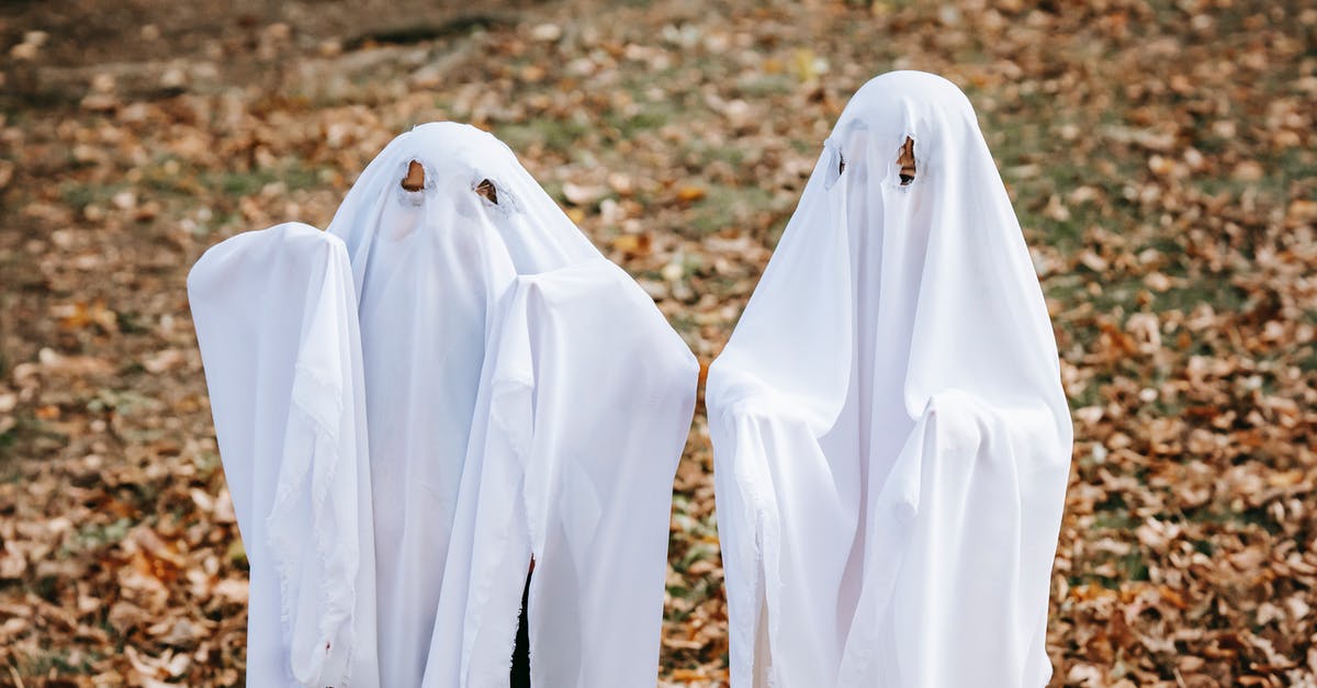 No later than which week in October should autumn foliage be seen, in Ontario? - Anonymous kids in scary ghost costumes standing on fallen leaves in autumn park