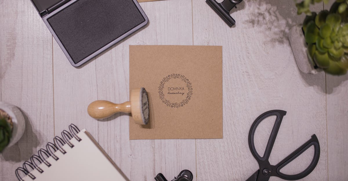 No stamp when going from India to Glasgow through Dublin - Top view of traditional rubber stamp and ink pad placed on wooden table near spiral notepad and composed with stationery and potted plants