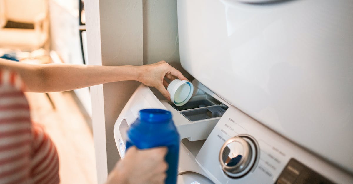 Non-biological laundry detergent available in the US? - A Person Pouring Detergent in a Washing Machine