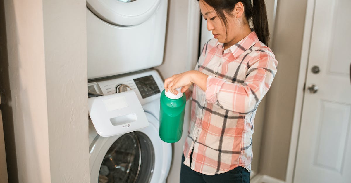 Non-biological laundry detergent available in the US? - A Woman Holding a Bottle of Detergent